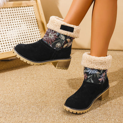 Pair of black women's ankle boots with floral embroidered cuff and warm lining, ideal for cold weather.