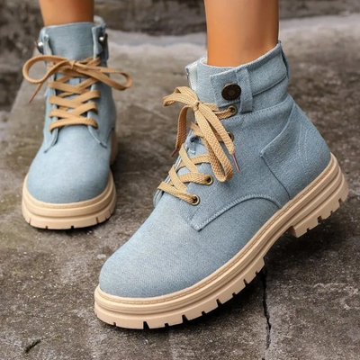 Fashionable light blue denim lace-up ankle boots with tan soles, perfect for casual wear.