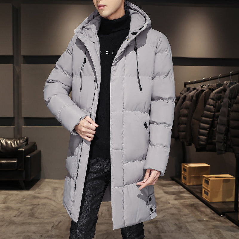 A gray long padded jacket with a hood, perfect for winter.