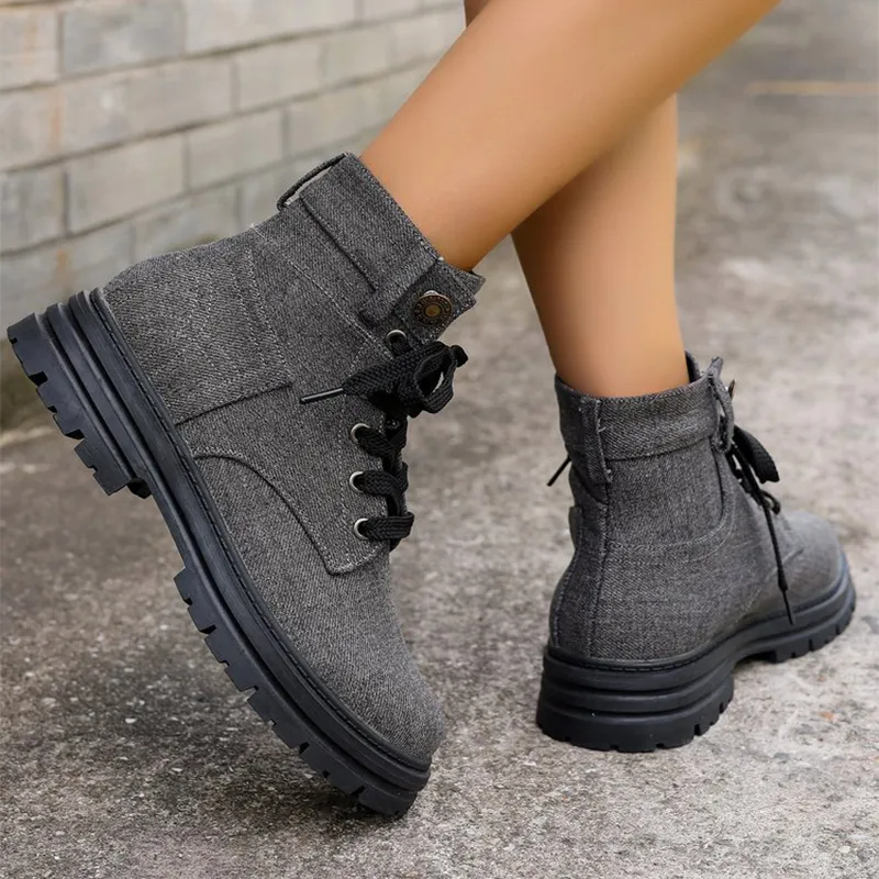 Pair of women's gray canvas lace-up boots with a stylish and comfortable design.