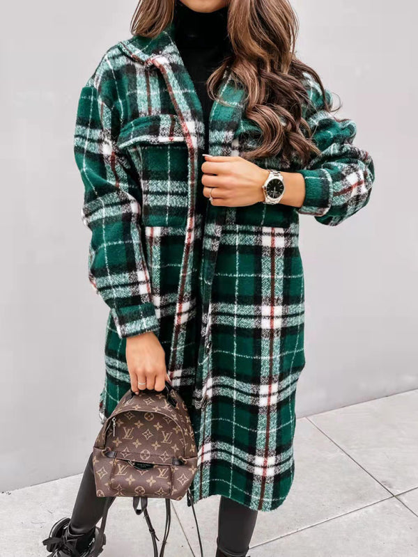 Woman wearing a green and white plaid coat with a button front and two chest pockets.