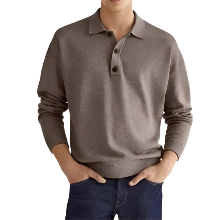 A man wearing a brown polo sweater paired with jeans.