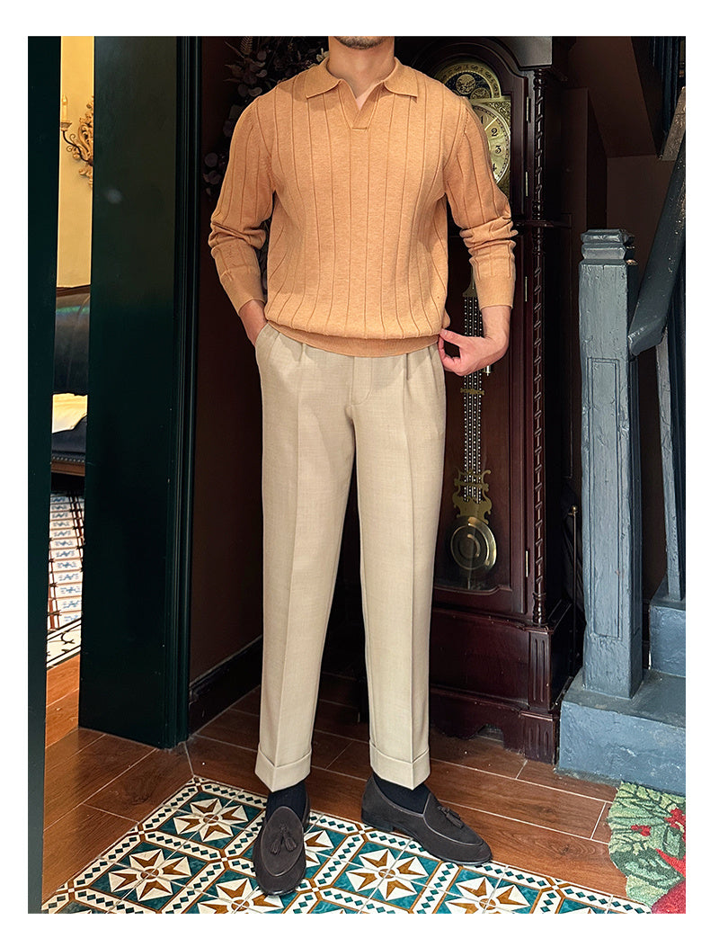 Full view of a men's beige knit sweater with a collared neckline and ribbed texture, worn with beige trousers and loafers.