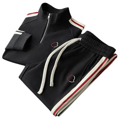 Men's black tracksuit with red and white stripe accents and zip-up top.