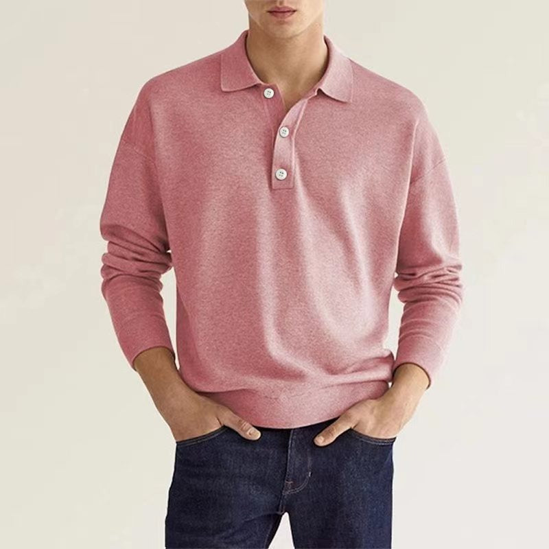 A man dressed in a pink polo sweater matched with dark denim.