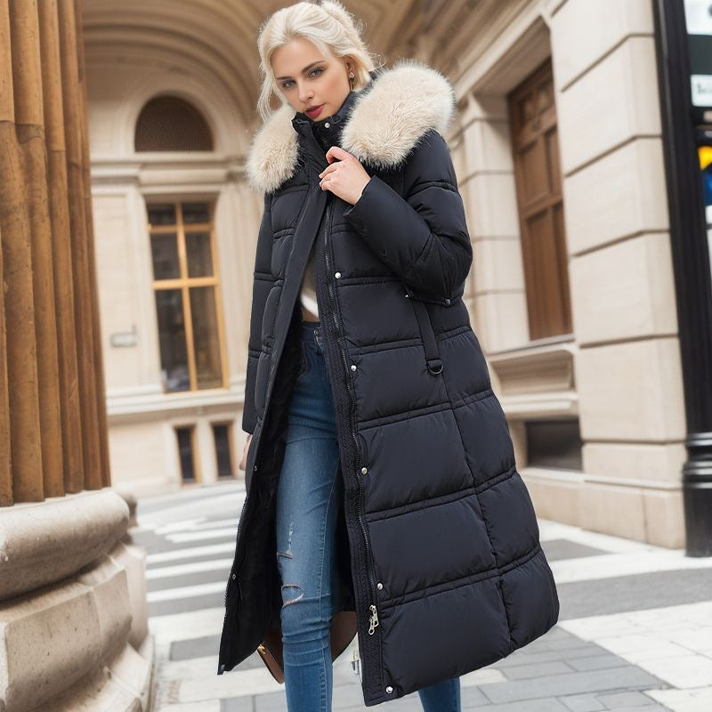 A woman dressed in a black down coat with a fur collar, exuding warmth and style during the cold season.