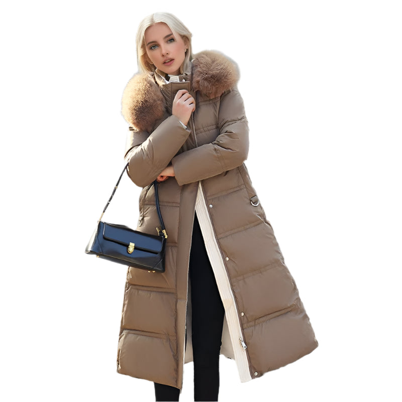 A woman wearing a chic long coat with a fur collar, showcasing a fashionable look in a simple setting.