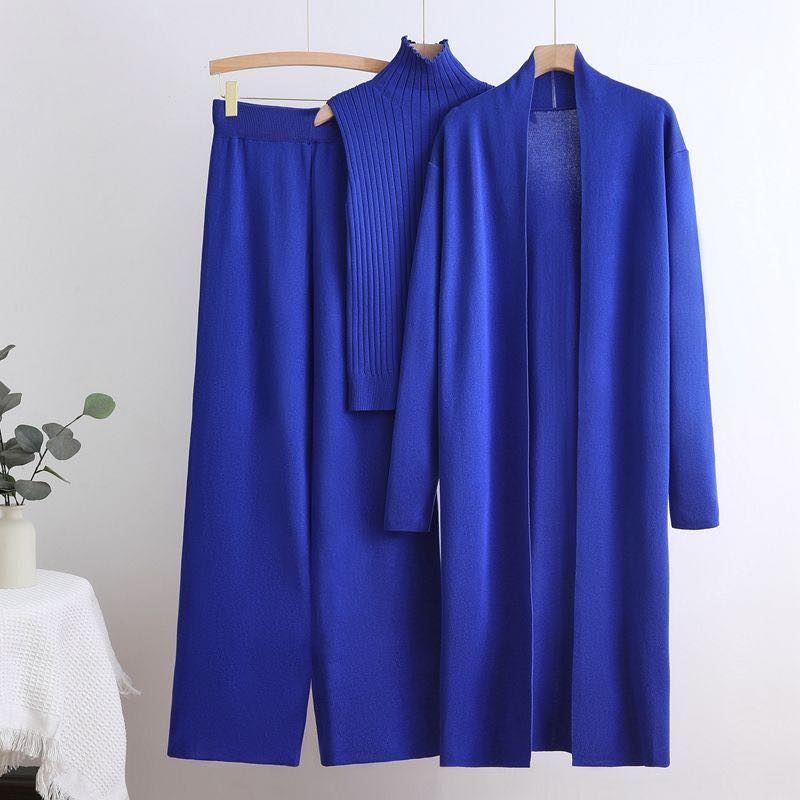 Women's blue knitted three-piece set with long cardigan, wide-leg pants, and sleeveless top