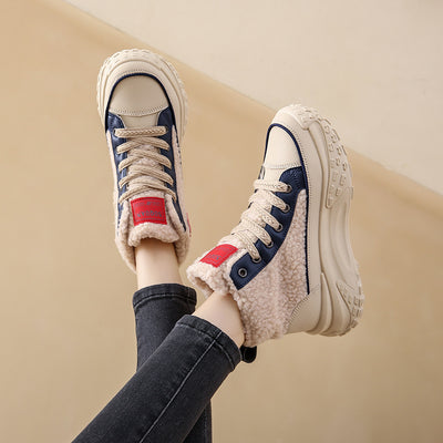 Women's beige high-top sneakers with blue accents, thick platform soles, and a warm faux fur lining